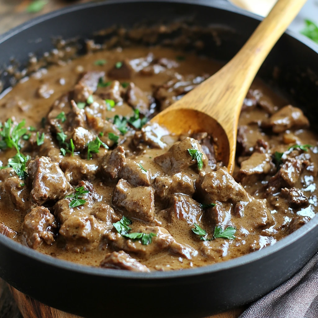 Classic Beef Stroganoff Recipe with creamy sauce, tender beef strips, and mushrooms served over a bed of pasta.