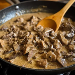 Classic Beef Stroganoff Recipe with creamy sauce, tender beef strips, and mushrooms served over a bed of pasta.