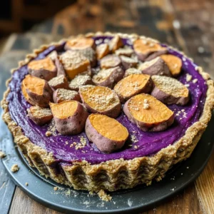 A vibrant purple sweet potatoes pie with a golden crust, served on a white plate, garnished with whipped cream and a sprinkle of cinnamon.